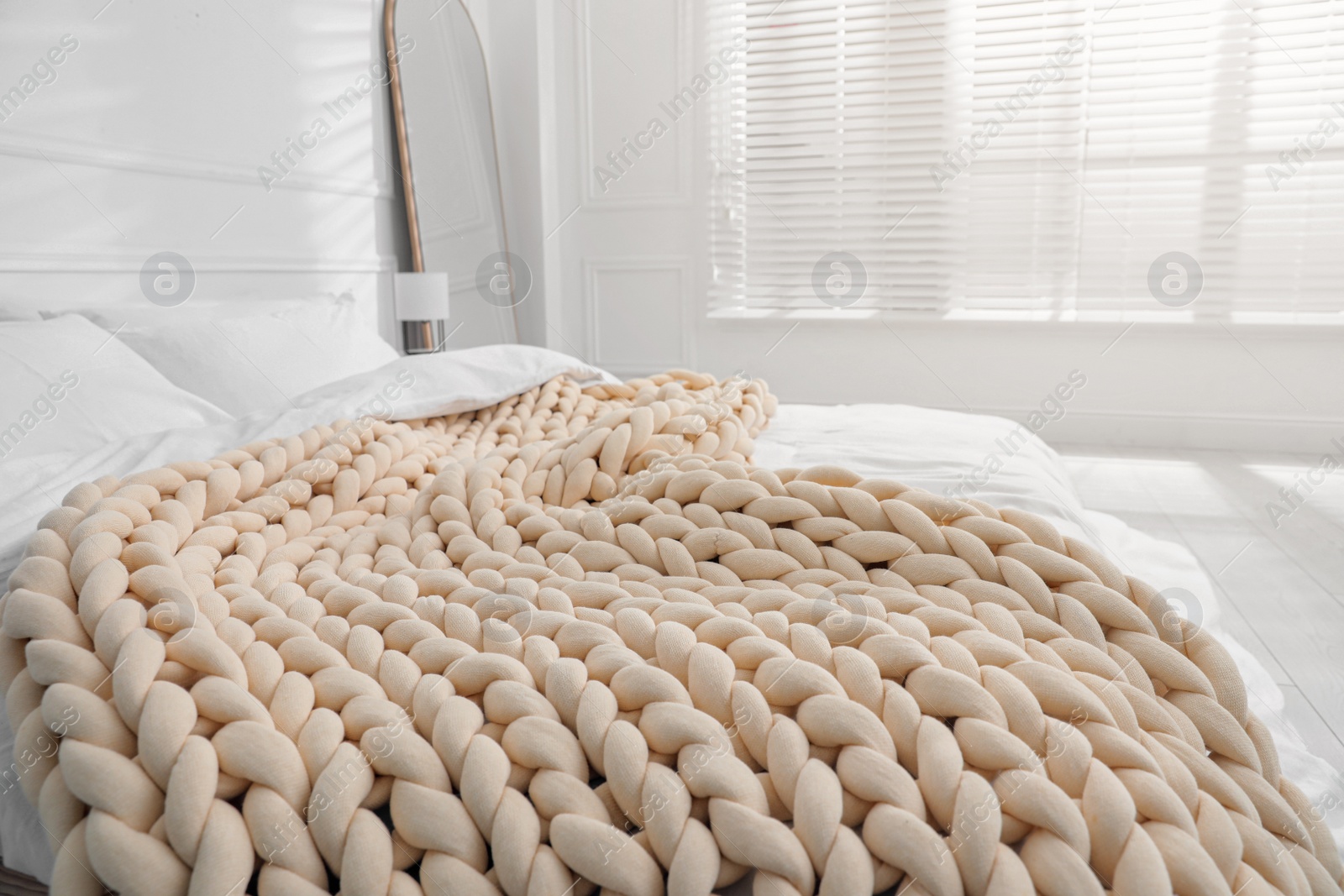 Photo of Soft chunky knit blanket on bed indoors