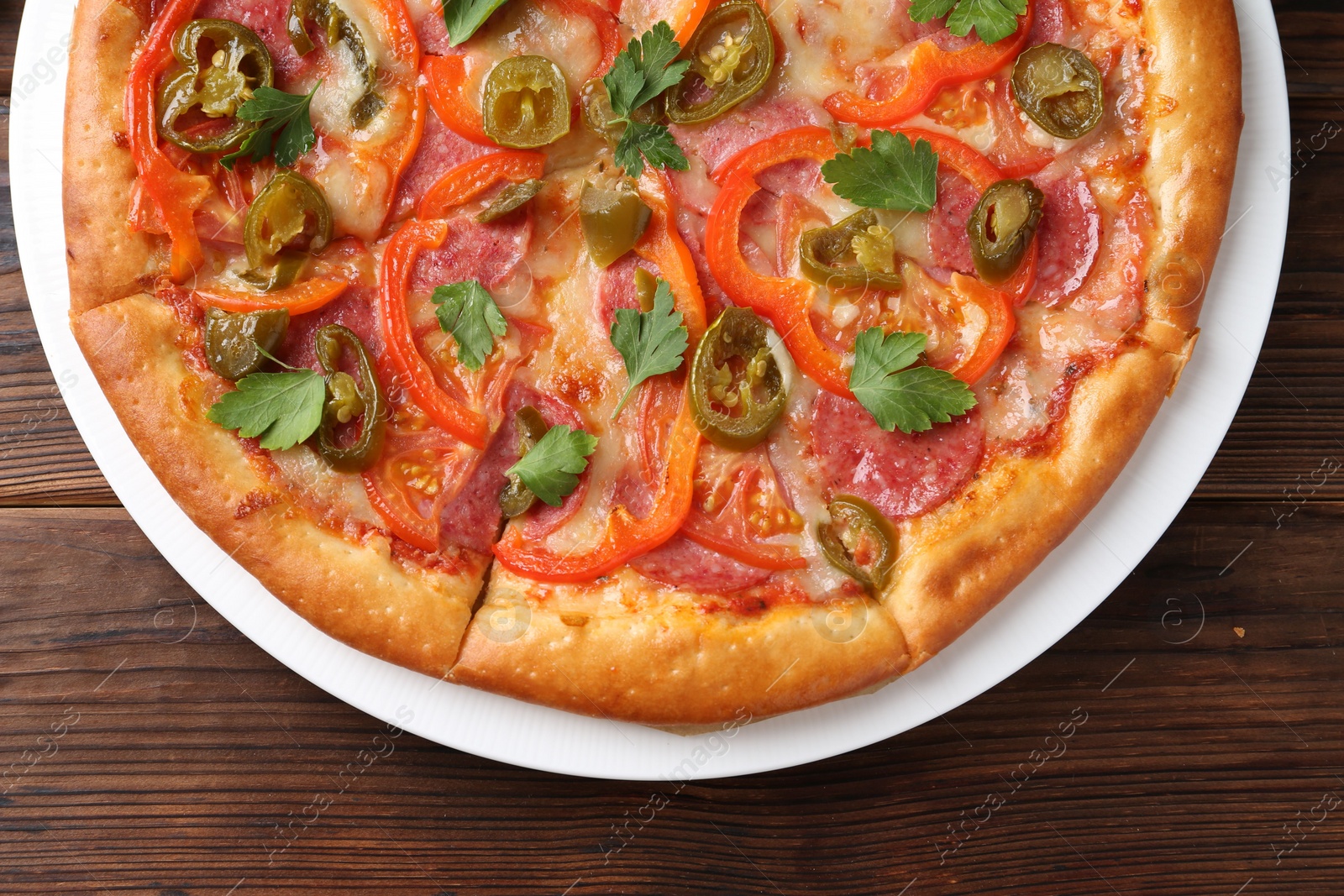 Photo of Delicious pizza Diablo on wooden table, top view