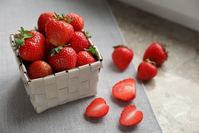 Photo of Whole and cut fresh juicy strawberries on table