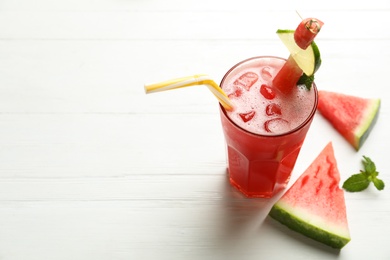 Delicious fresh watermelon drink on white wooden table. Space for text