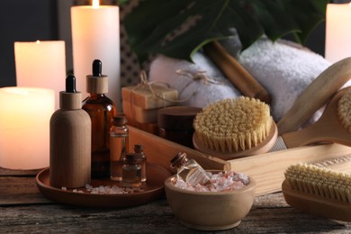 Photo of Composition with different spa products and candles on wooden table