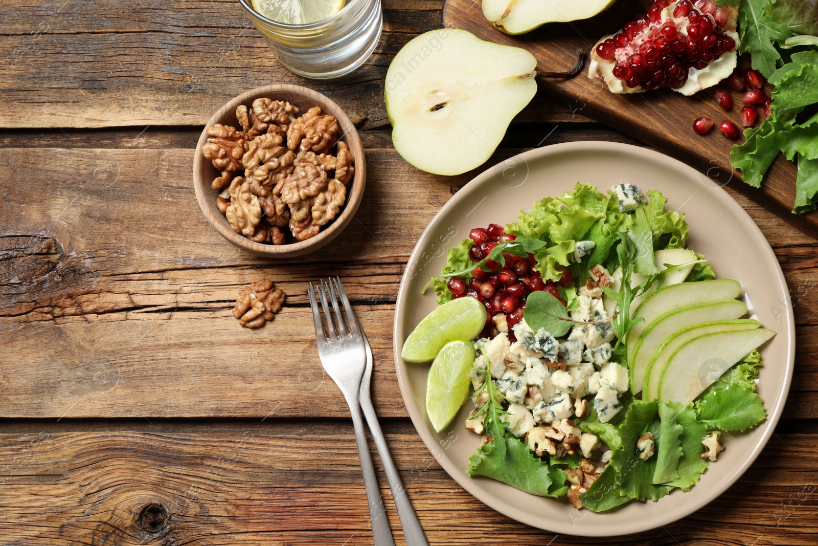 Photo of Fresh salad with pear on wooden table, flat lay