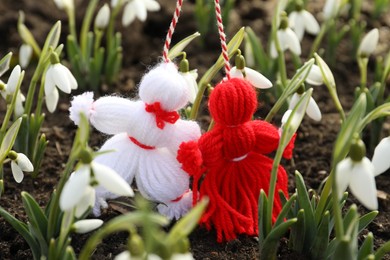 Photo of Traditional martisor among beautiful snowdrops outdoors. Beginning of spring celebration