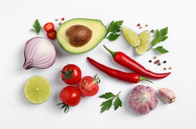 Fresh ingredients for guacamole on white background, flat lay