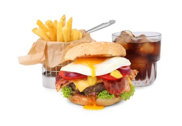 Delicious burger with fried egg, french fries and soda drink isolated on white