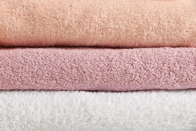 Photo of Dry soft folded towels as background, closeup