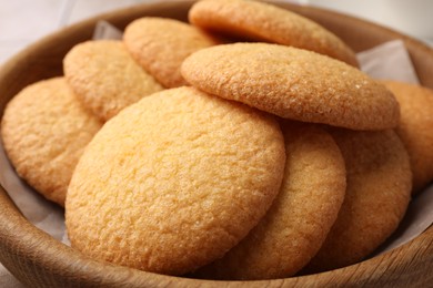 Photo of Delicious Danish butter cookies in wooden bowl, closeup
