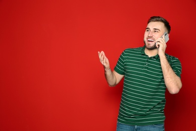 Photo of Portrait of man talking on phone against color background. Space for text