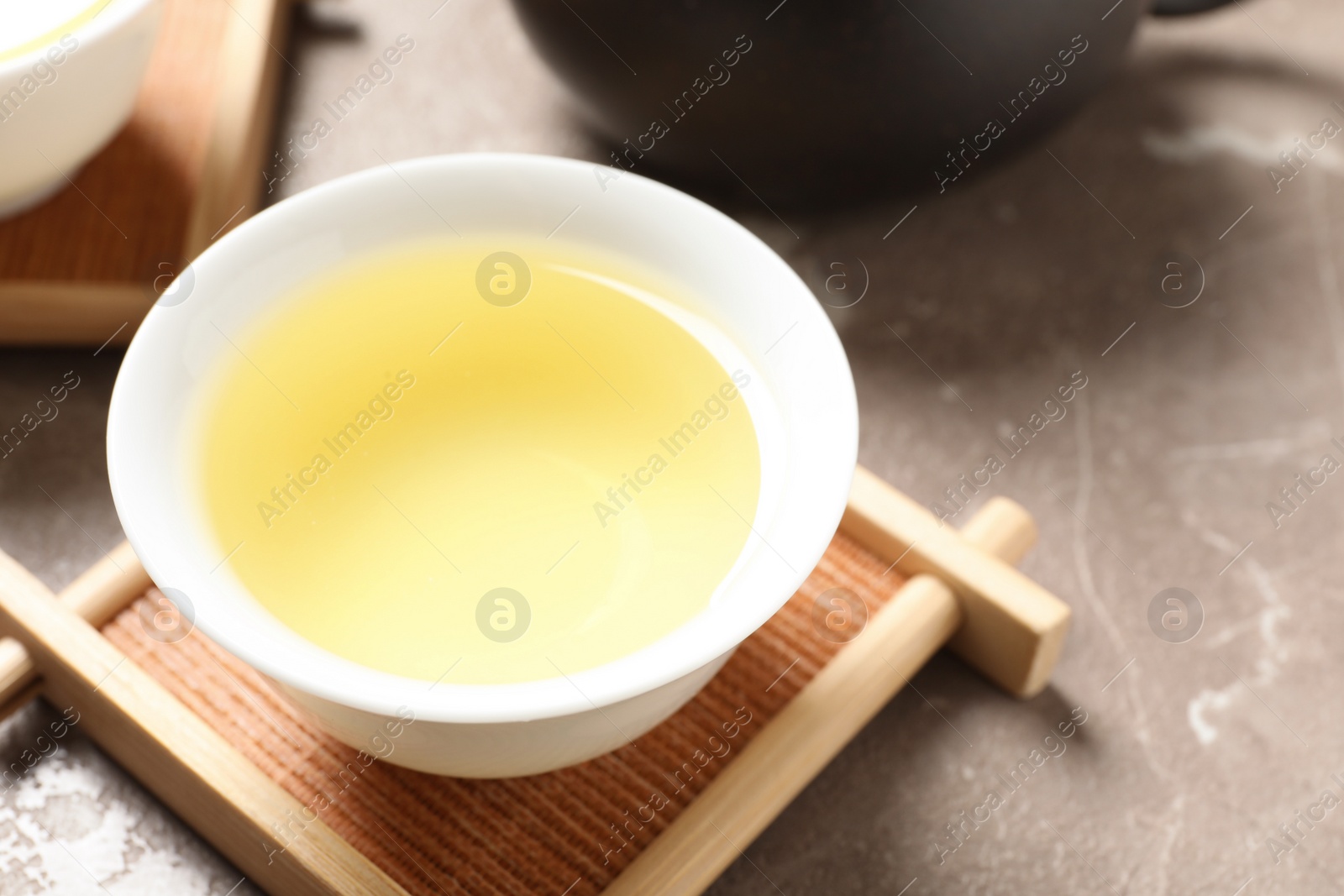 Photo of Cup of Tie Guan Yin oolong tea on table, closeup