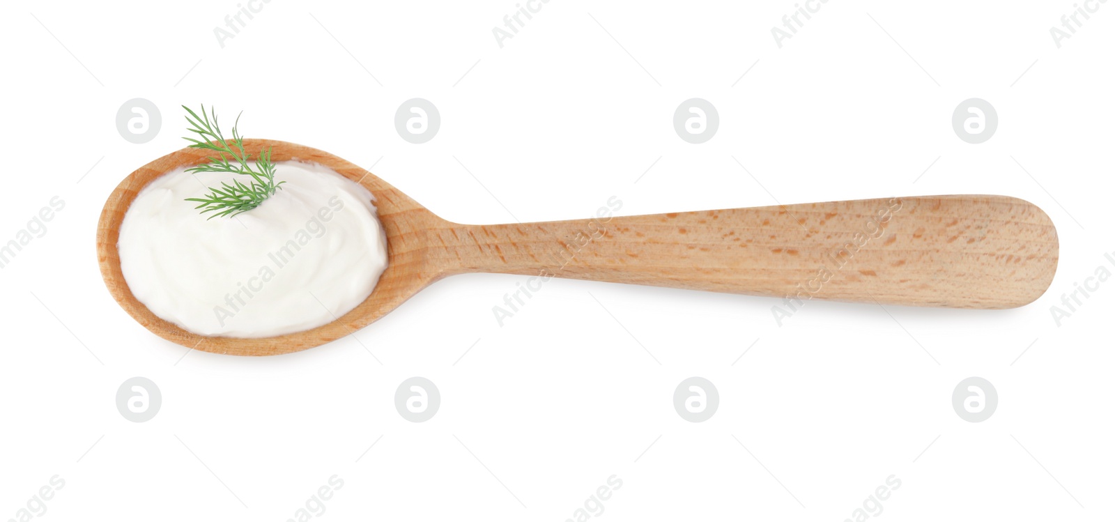 Photo of Delicious sour cream with dill in wooden spoon on white background, top view