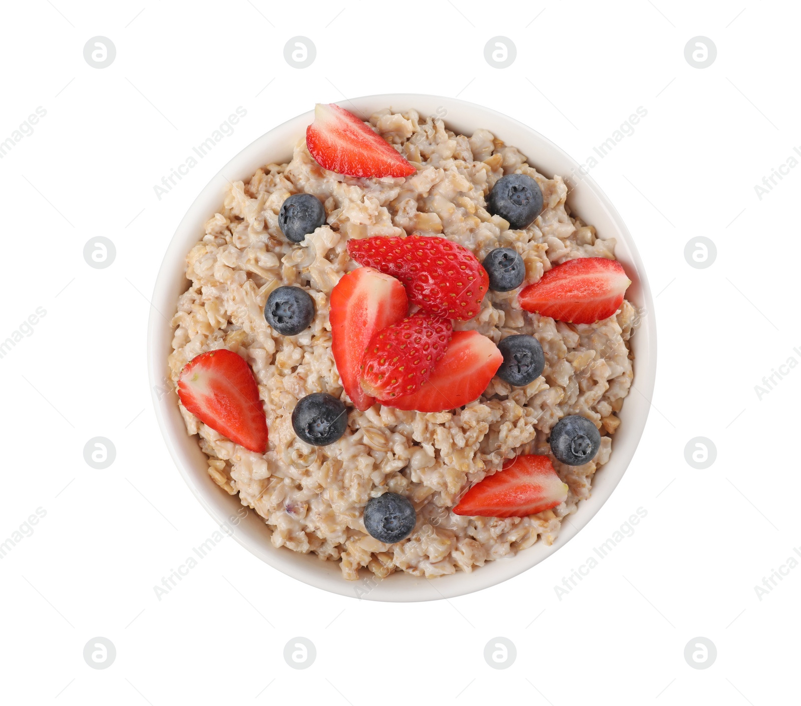 Photo of Tasty boiled oatmeal with berries in bowl isolated on white, top view