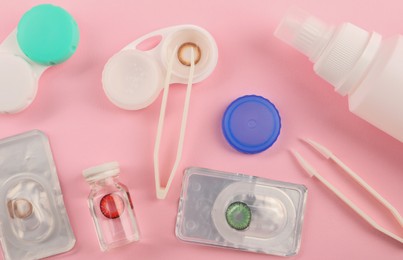 Photo of Flat lay composition with color contact lenses on pink background