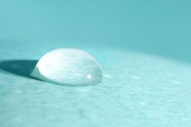Macro photo of water drop on turquoise background