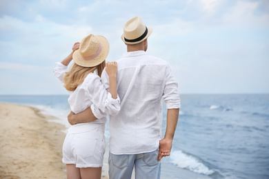 Photo of Happy couple having romantic walk on beach
