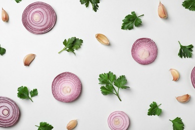 Photo of Flat lay composition with green parsley, onion and garlic on light background