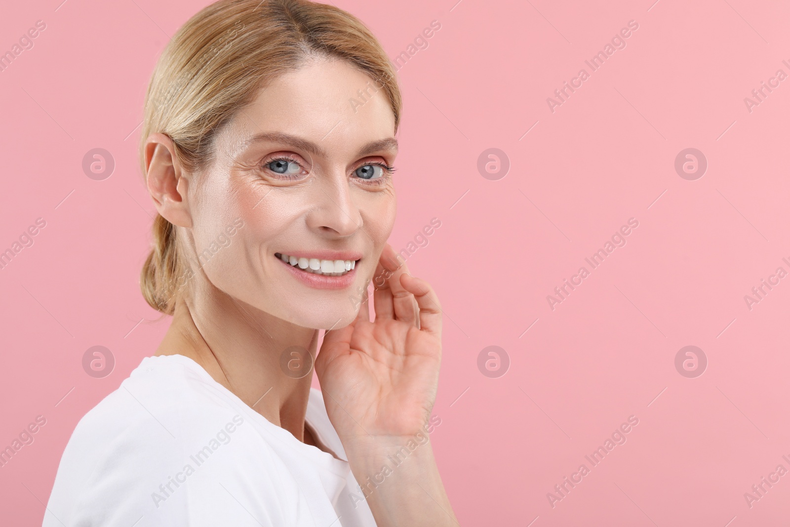 Photo of Woman with clean teeth smiling on pink background, space for text