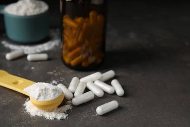 Photo of Amino acid pills and powder on grey table