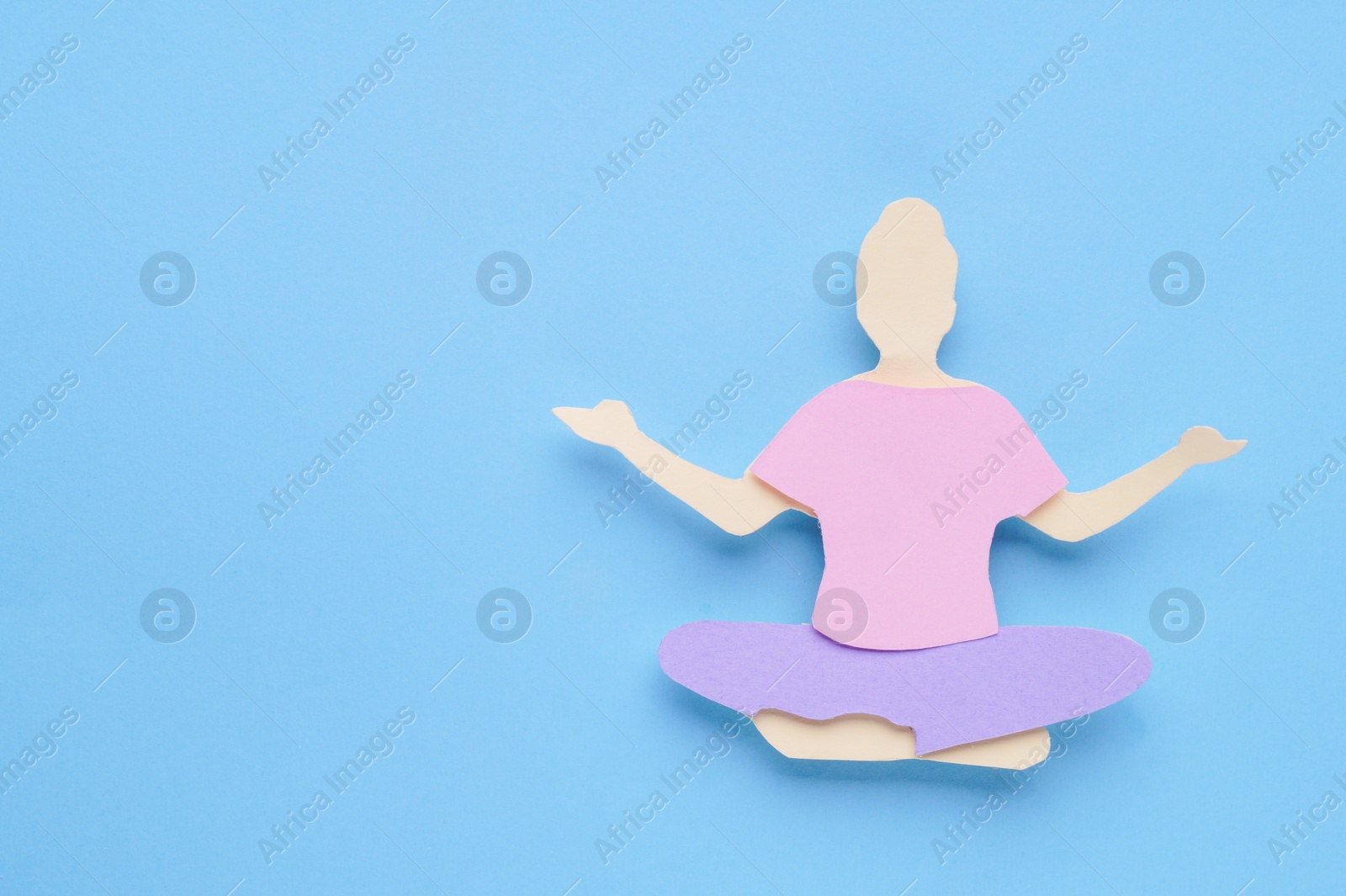 Photo of Woman`s health. Paper female figure on light blue background, top view with space for text