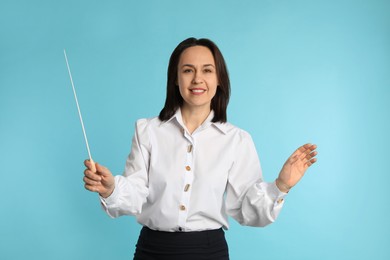 Photo of Music teacher with baton on turquoise background
