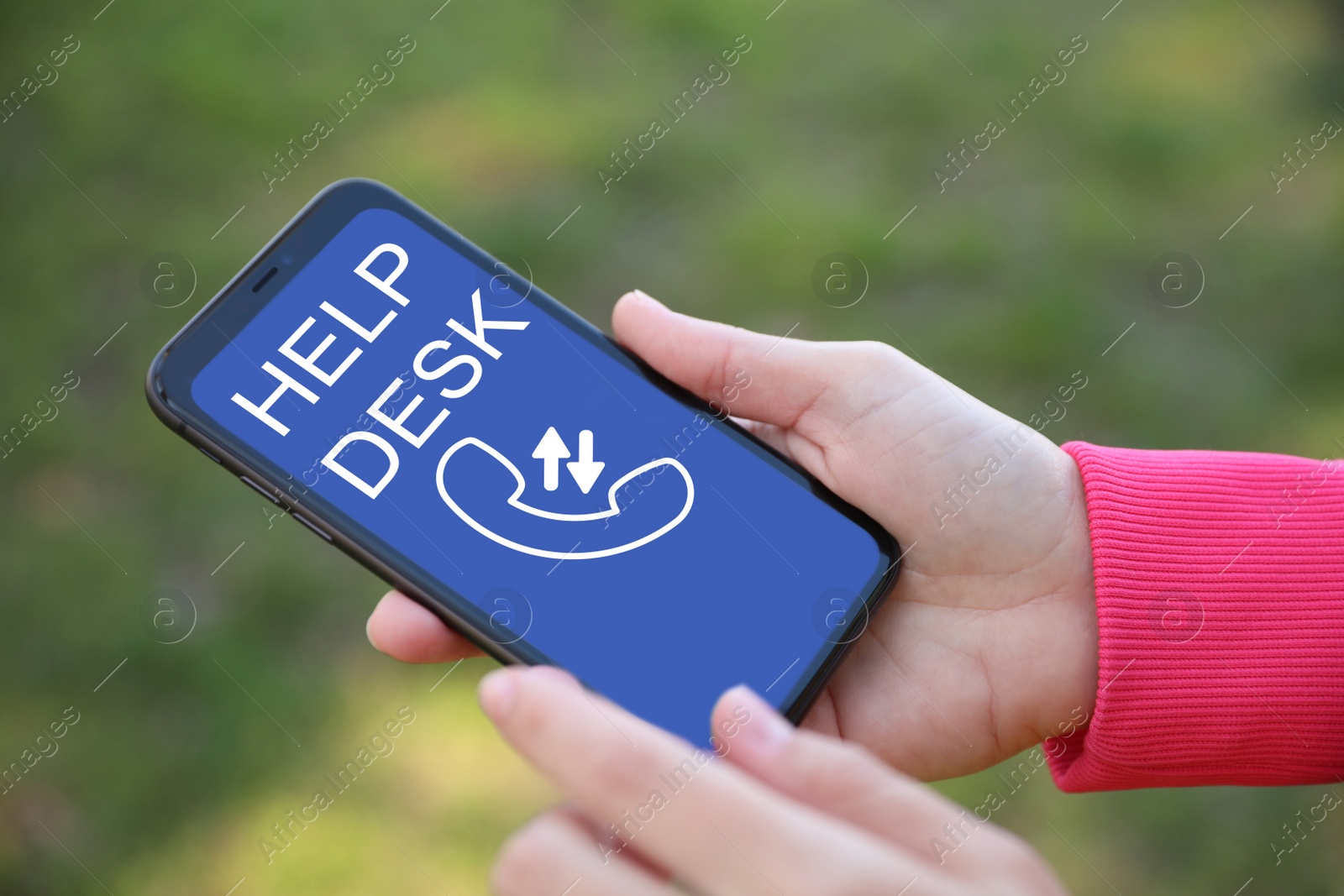 Image of Woman calling to help desk service with smartphone outdoors, closeup