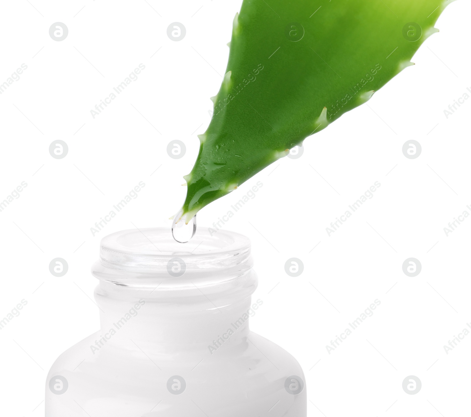 Photo of Aloe juice dripping from leaf into bottle on white background