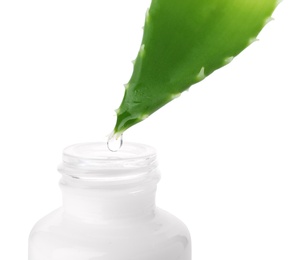 Photo of Aloe juice dripping from leaf into bottle on white background