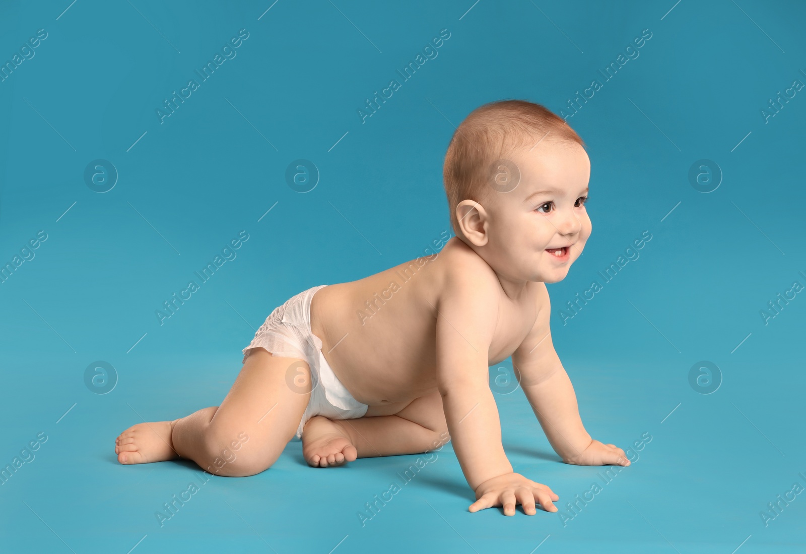 Photo of Cute little baby in diaper on light blue background