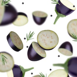 Cut eggplants, rosemary and peppercorns falling on white background