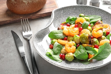 Plate of warm salad with Brussels sprouts on table