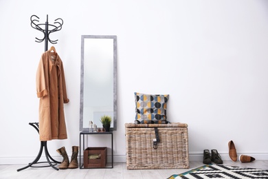 Stylish hallway interior with mirror and rack