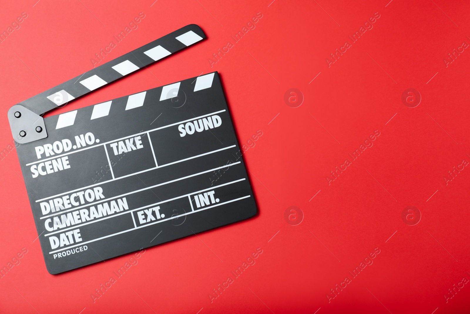 Photo of Clapper board on red background, top view with space for text. Cinema production