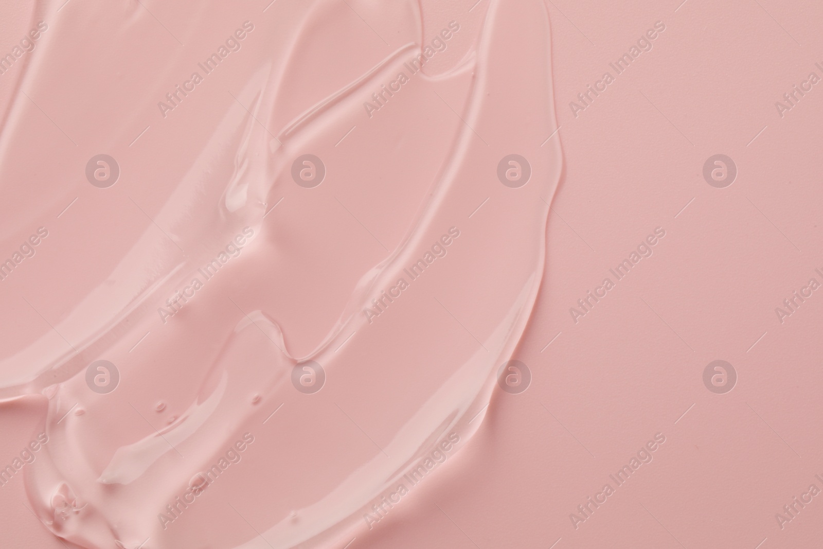 Photo of Clear cosmetic gel on pink background, top view. Space for text