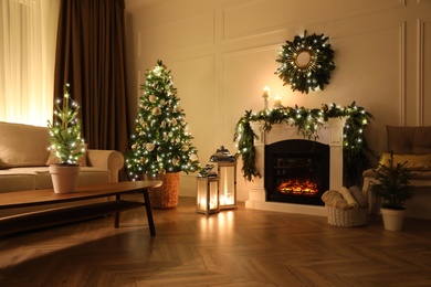 Photo of Beautiful room interior with fireplace and Christmas decor in evening