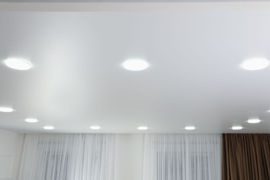 White ceiling with lamps indoors, below view