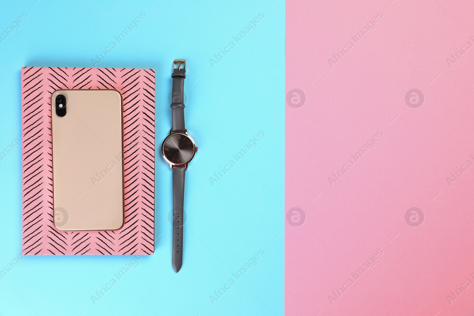 Photo of Planner with smartphone and wristwatch on colorful background, top view. Space for text