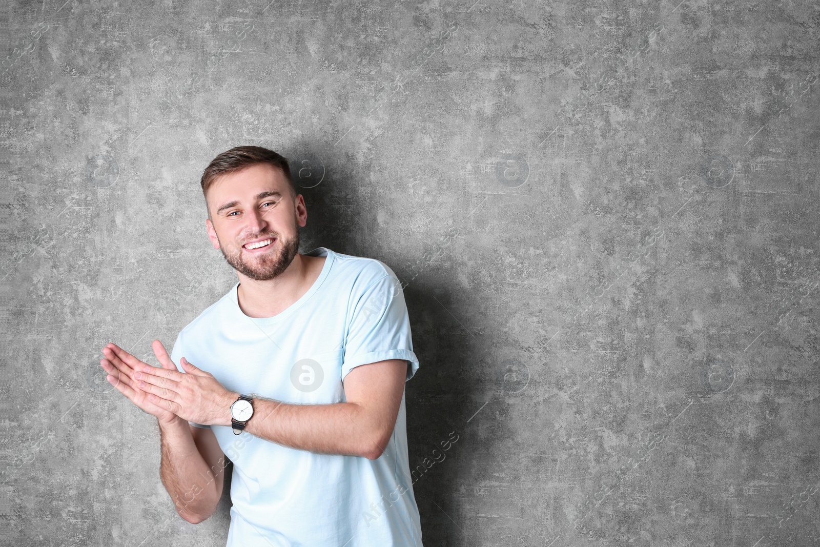 Photo of Portrait of handsome happy man on grey background, space for text