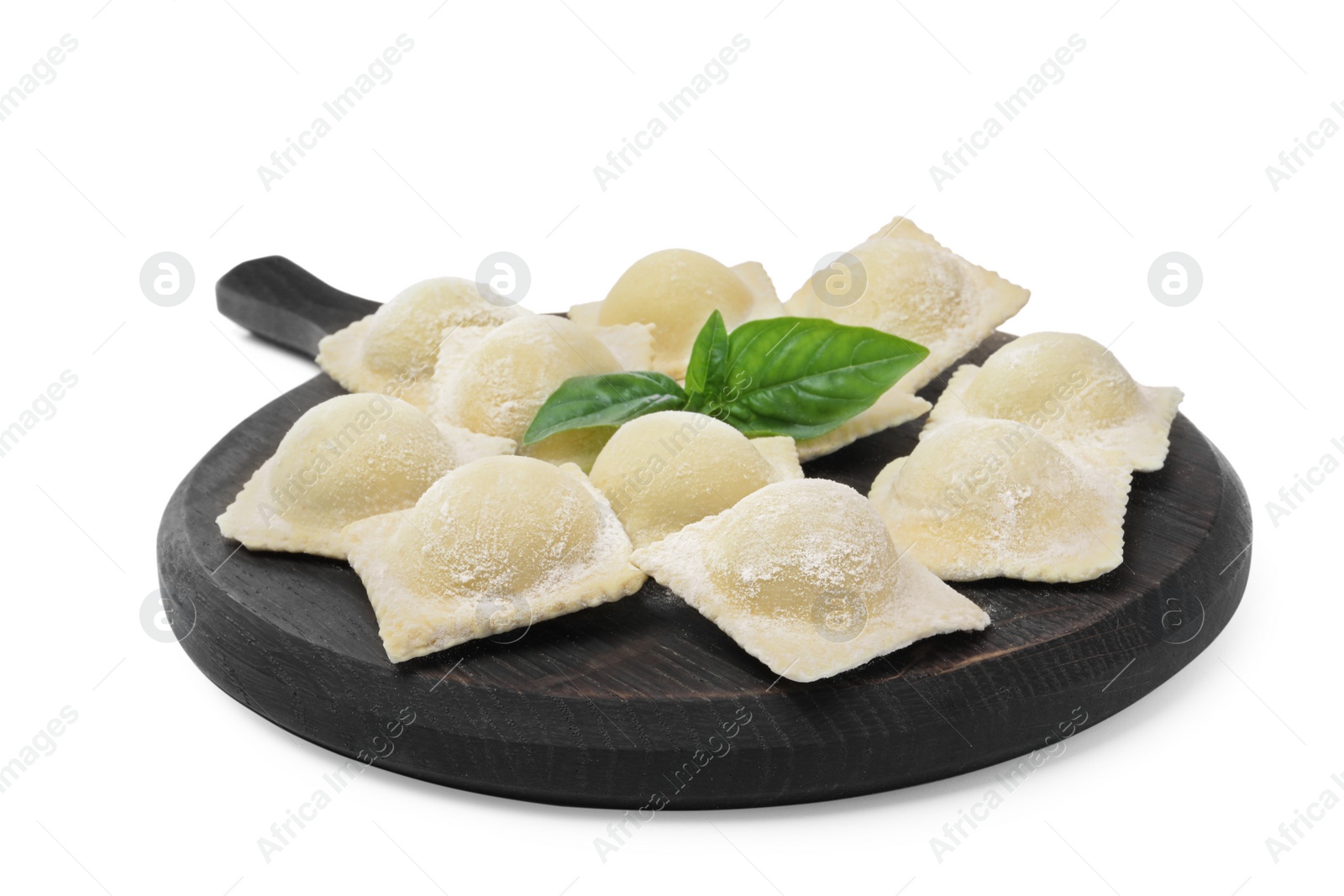 Photo of Uncooked ravioli and basil on white background