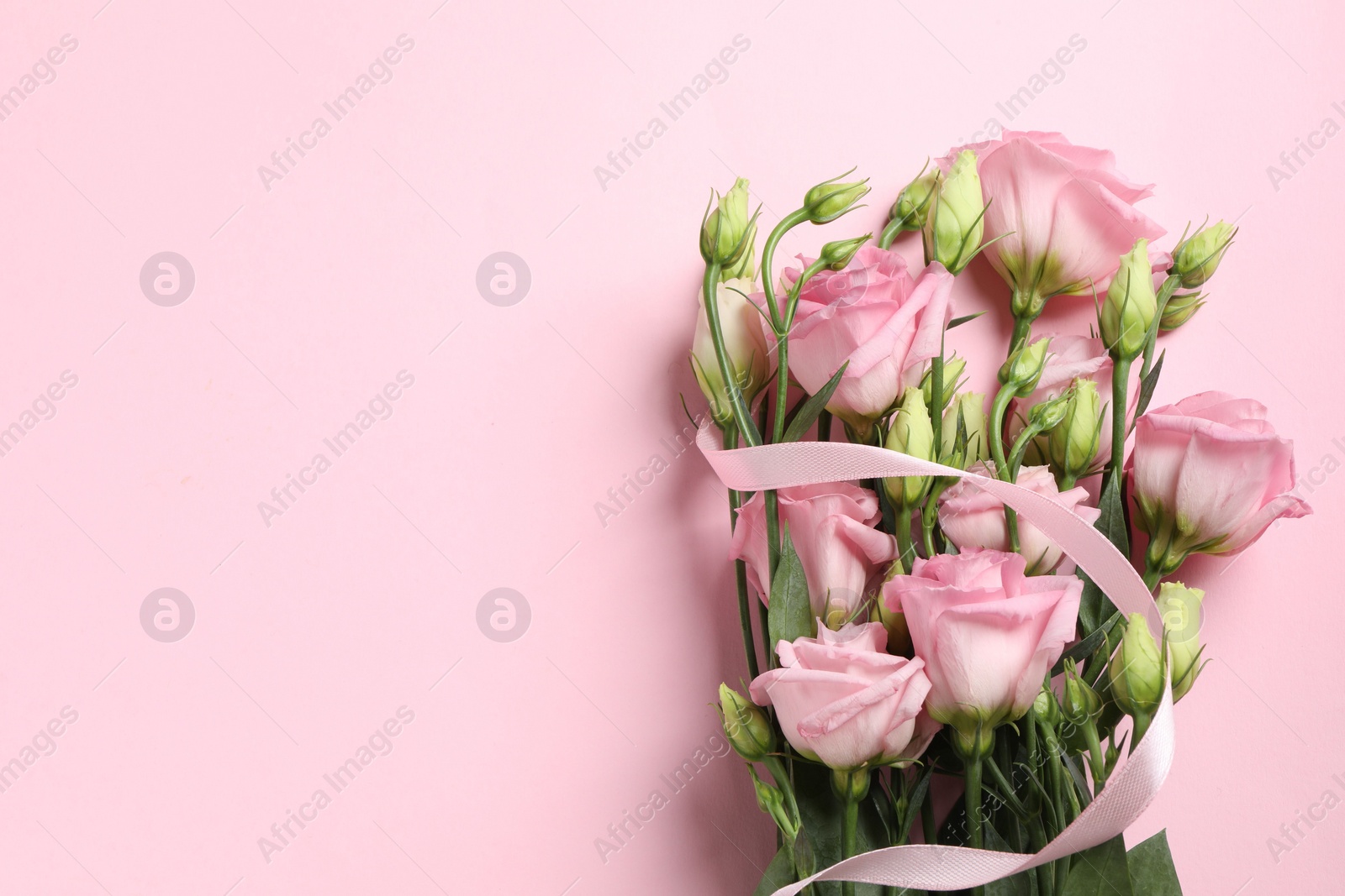 Photo of Happy Mother's Day. Beautiful flowers and ribbon on pink background, top view. Space for text