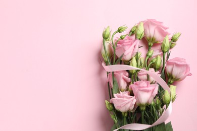 Happy Mother's Day. Beautiful flowers and ribbon on pink background, top view. Space for text