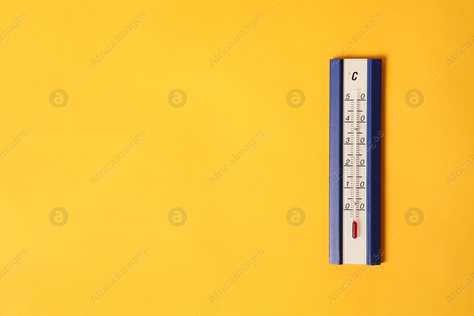 Photo of Weather thermometer on yellow background, top view. Space for text