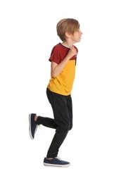 Photo of Cute little boy running on white background