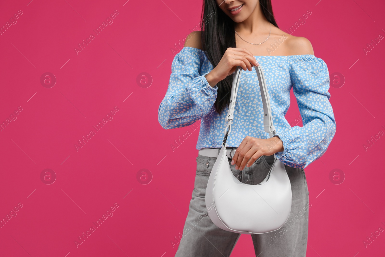 Photo of Fashionable young woman with stylish bag on pink background, closeup. Space for text
