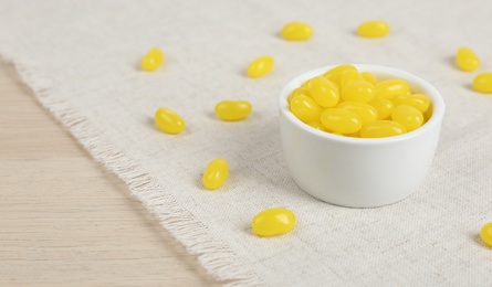 Photo of Many tasty lemon drops on wooden table