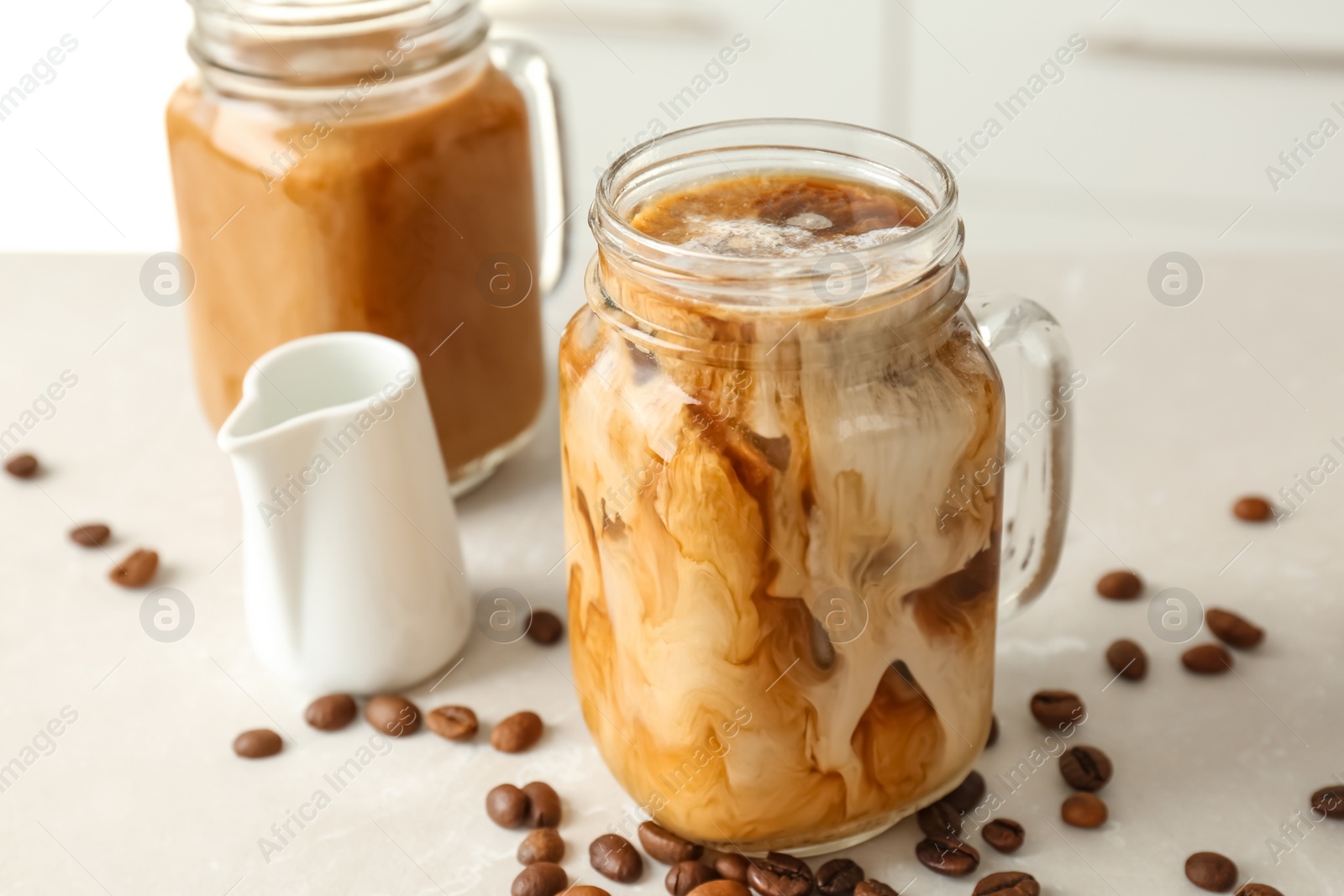 Photo of Mason jar with cold brew coffee on table