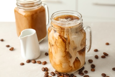 Photo of Mason jar with cold brew coffee on table