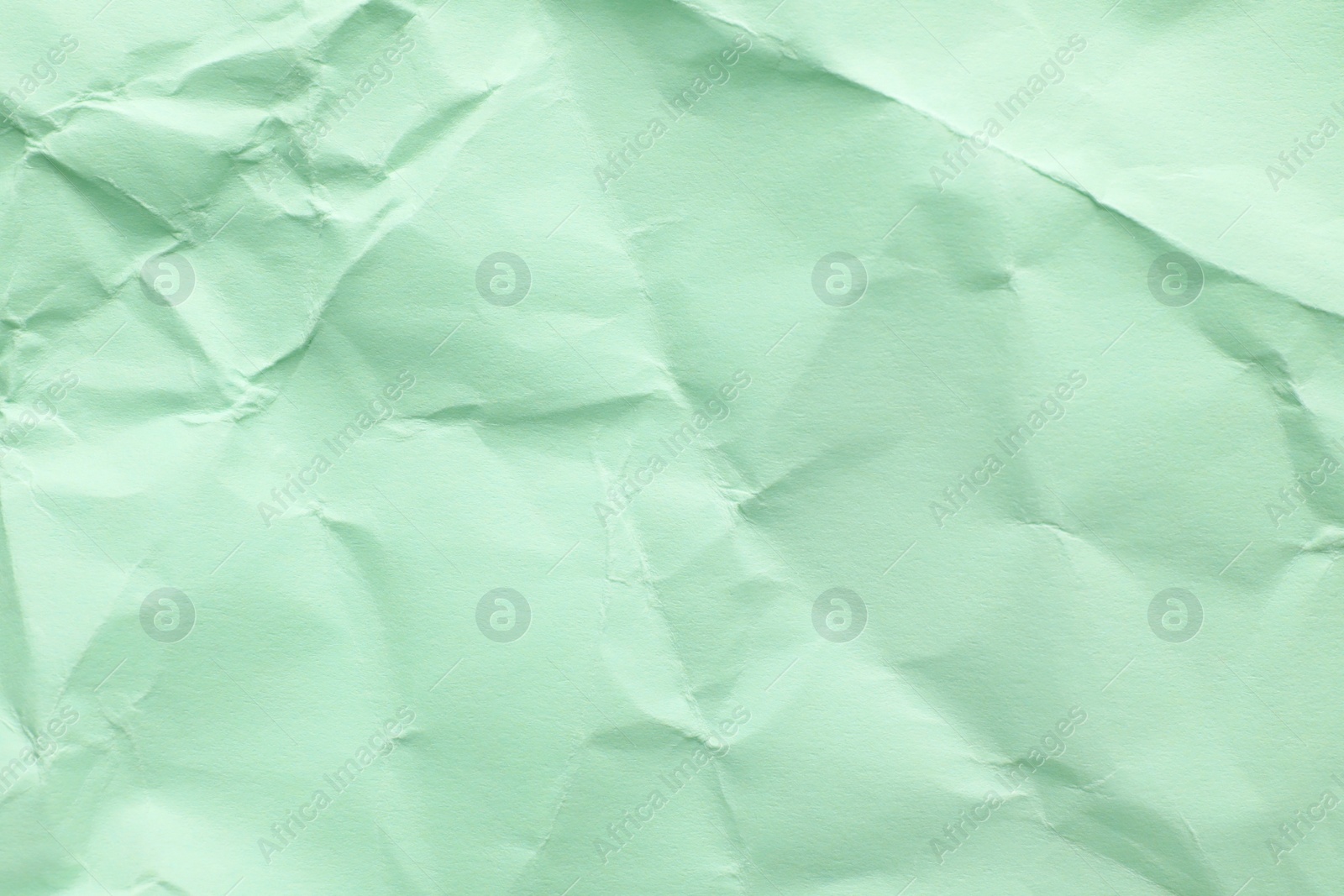 Photo of Sheet of color crumpled paper as background. Space for design