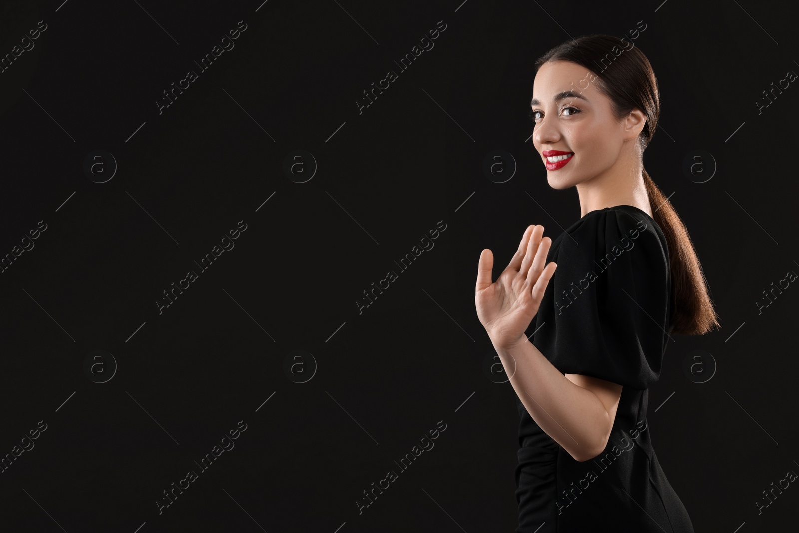 Photo of Beautiful young woman on black background, space for text