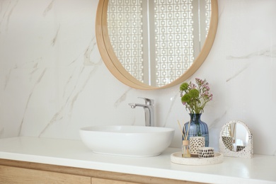 Modern bathroom interior with stylish mirror and vessel sink