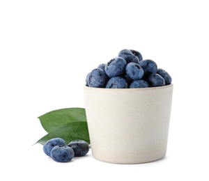 Bowl full of fresh ripe blueberries on white background