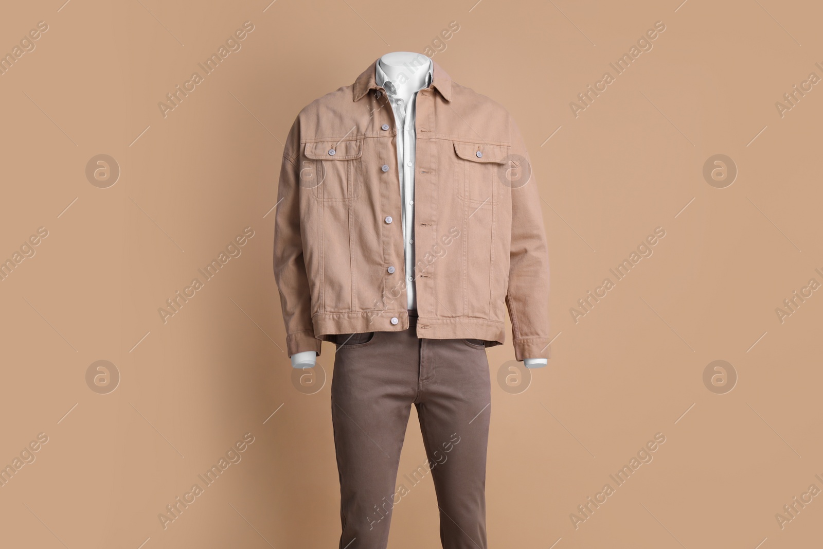 Photo of Male mannequin dressed in white shirt, jacket and pants on beige background